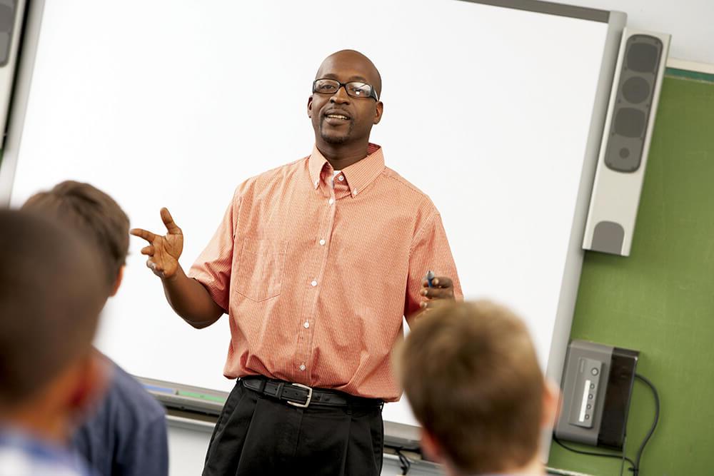 Male teacher speaking to students